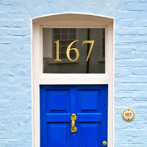 Gold house number sticker above a front door