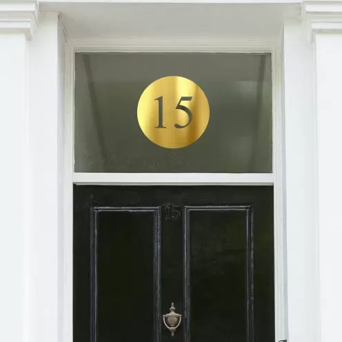 Transom above a front door with gold house number sticker