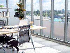 An office with a desk and chair and window film